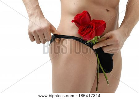 Handsome man holding a red rose and a bouquet of red roses. Sexy man gives a rose on a white background with a beautiful light. Isolated on white background