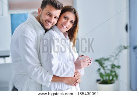 Young goodlooking couple posing in their kitchen.