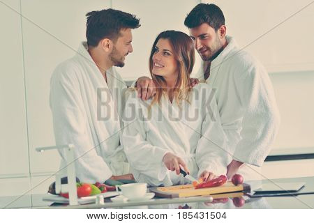 Happy couple cooking breakfast together in the kitchen.