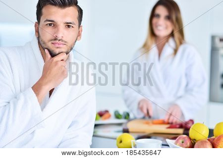 Happy couple cooking breakfast together in the kitchen.
