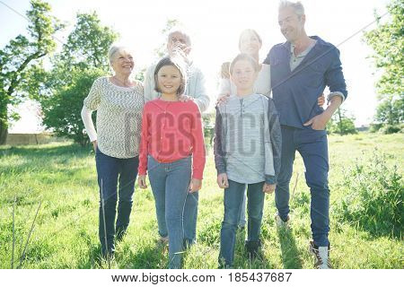 Happy intergenerational family walking in park