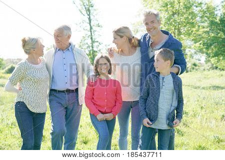 Intergenerational family walking together in park