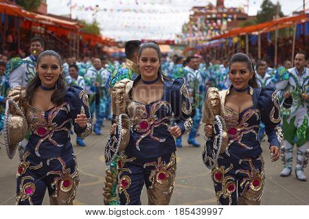 ORURO, BOLIVIA - FEBRUARY 26, 2017: Caporales dancers in ornate costumes performing as they parade through the mining city of Oruro on the Altiplano of Bolivia during the annual carnival.