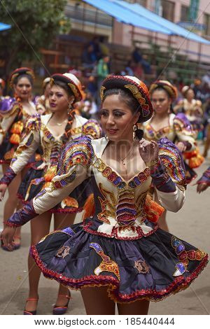 ORURO, BOLIVIA - FEBRUARY 26, 2017: Caporales dancers in ornate costumes performing as they parade through the mining city of Oruro on the Altiplano of Bolivia during the annual carnival.
