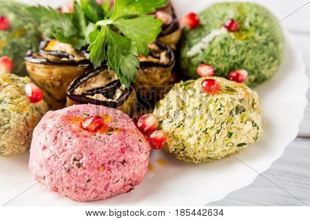 Spinach appetizer phali with pomegranate seeds close up. Georgian cuisine.