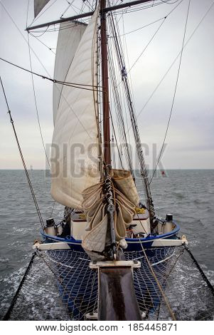 Sailing boat on Nothern Sea sails wind water storm front