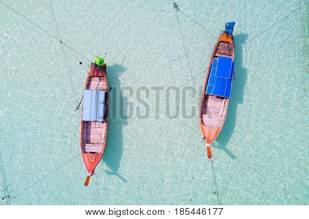Aerial view over group of long tail boatsTop view from drone Koh Lipe island SatunThailand.