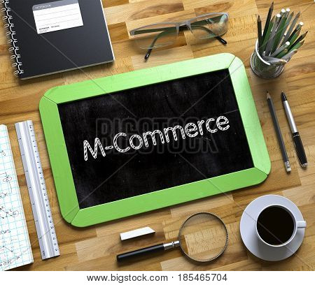 M-Commerce Handwritten on Green Small Chalkboard. Top View of Wooden Office Desk with a Lot of Business and Office Supplies on It. M-Commerce on Small Chalkboard. 3d Rendering.