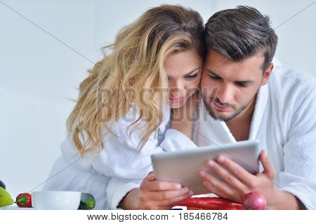 Happy couple cooking breakfast together in the kitchen.