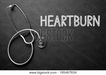 Medical Concept: Heartburn Handwritten on Black Chalkboard. Top View of White Stethoscope on Chalkboard. 3D Rendering.
