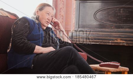 Old Woman pensioner granny - speak landline telephone, telephoto, cllose up