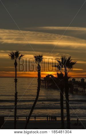 Looking down to the beach and the Oceanside Pier. Watching surfers as the sun goes down.