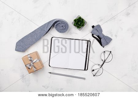 Happy Fathers Day mockup with notebook gift glasses necktie and bowtie on white background top view in flat lay style.