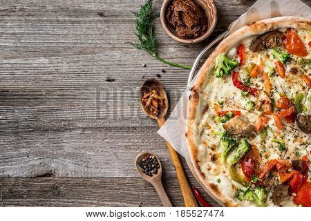Delicious big vegan pizza with broccoli, greens and mushrooms, additional textspace left on side