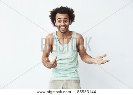 Happy and confident african man smiling pointing finger at himself inviting to a party over white background. Copy space.
