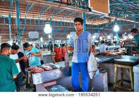 Bandar Abbas Hormozgan Province Iran - 16 april 2017: The young seller demonstrates its goods in the fish market.