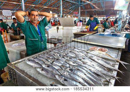 Bandar Abbas Hormozgan Province Iran - 16 april 2017: One seller of fish in green overalls in the indoor fish market.