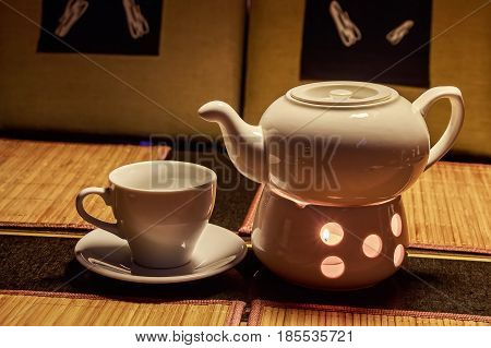 Teapot and cups are prepared for tea drinking in cafe