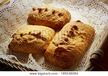 Close up fresh home made puffs with metal pastry tongs