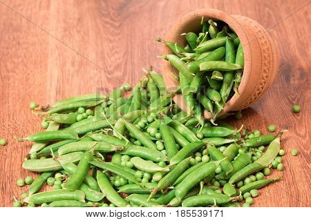 Fresh green peas close-up on wooden background.Vegetables from the garden. Summer