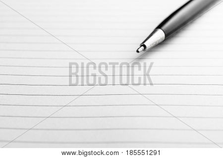 Opened notepad and pen on white background