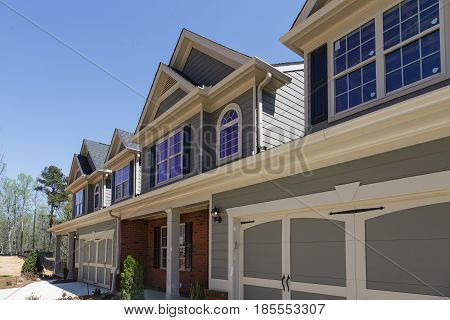 A row of modern townhouses in a new subdivision