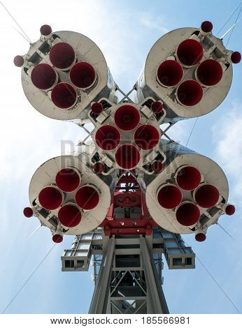 space rocket monument from below with red fuel nozzle