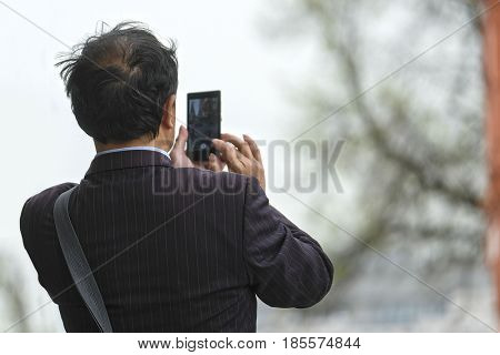 Moscow, Russia - May, 7, 2017: Tourists photograph on Red Square in a center of Moscow