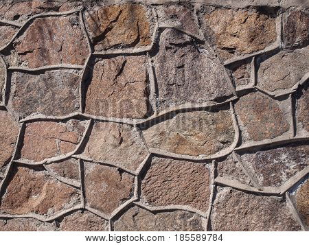 The wall of the large and rough stones. In warm tones