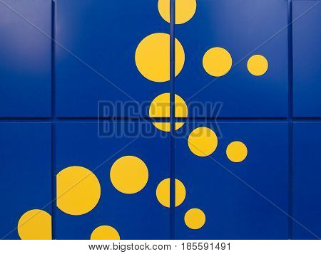 Background of Bright blue walls with large tiles and yellow spots