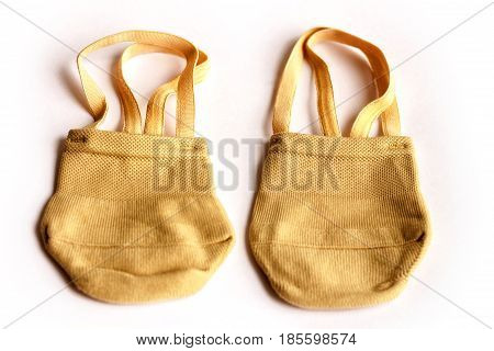 Rhythmic gymnastics shoes worn on white background.