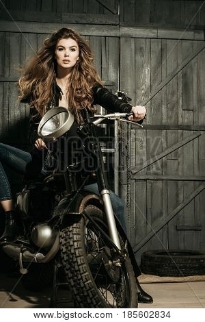 Biker In Leather Jacket Sitting On Vintage Motorcycle