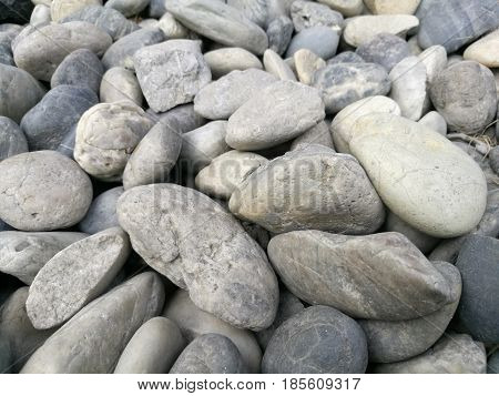 Pebble stone backgroundoutdoor natural river white grey rock pebbleabstract dry garden round stones textureMaterial for constructionnumerous pile pebble macro focus-on-foreground blur background