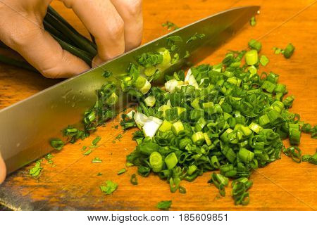 Chopped Green Onions On Wooden Cutting Board
