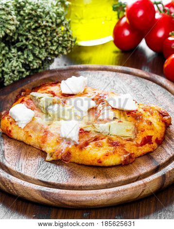 Pizza With Artichoke And Oregan On Wood