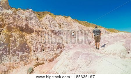  Little girl on a weekend hike with her dad in Paint Mines Interpretive Park in Colorado.