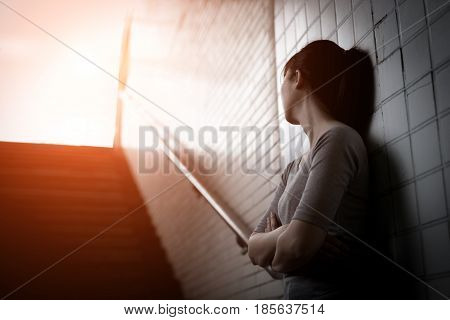 depressed woman sit and look somewhere in underground