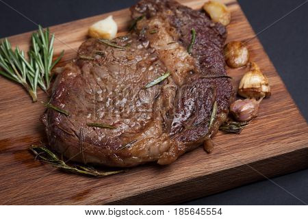 Grilled Rib-eye Steak Of Marble Beef Closeup With Spices On Wooden Board.