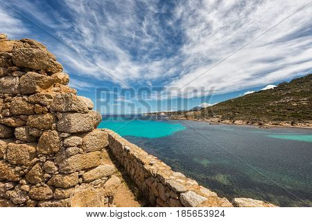 Stone Wall Of Derelict Building And Translucent Sea In Corsica