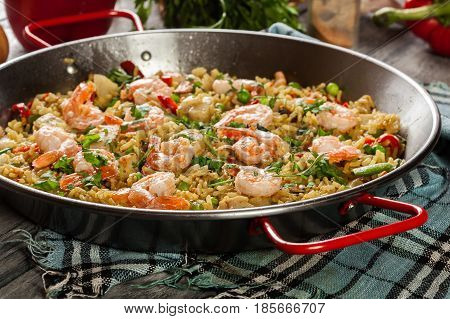 Traditional Seafood Paella With Shrimp, Fish And Chicken Seved In Paellera