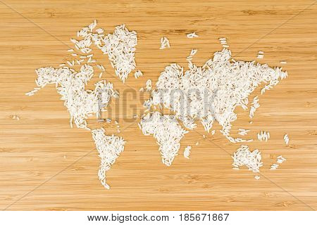 map of the world made of white rice on bamboo wood background