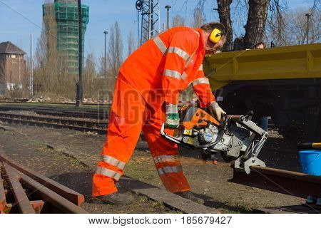 BERLIN - APRIL 21: Working Deutsche Bahn demonstrates working with cutting machine. Spring Festival Exhibition in the Rail yard Schoeneweide April 21 2013 in Berlin Germany