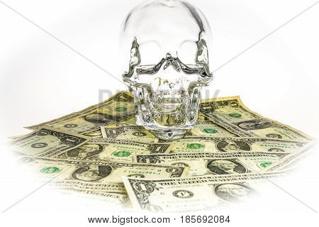 Crystal skull glass brainpan with dollars and white background