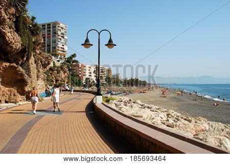 TORREMOLINOS, SPAIN - SEPTEMBER 3, 2008 - Tourists relaxing on the beach and promenade Torremolinos Malaga Province Andalusia Spain Western Europe, September 3, 2008.