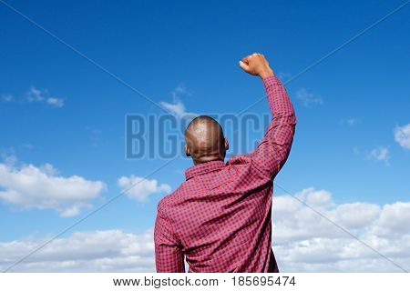 Back Of Man With Arm Raised In The Air