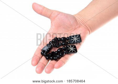 Rosary in hand on a white background isolated.