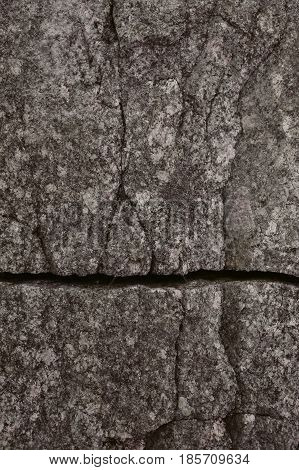 Old broken wall background.  Broken stone background. Abstract texture and background for designers. Stone wall textured. Close up view of aged stone wall. Rough texture.