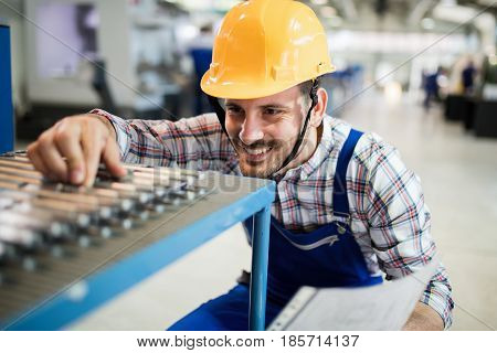 Supervisor doing quality control and pruduction check in metal factory