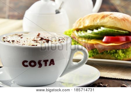 Composition With Cup Of Costa Coffee Coffee And Sandwich
