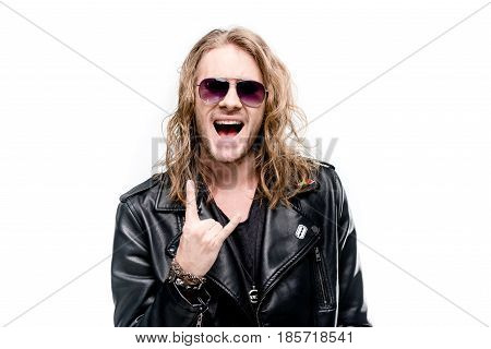portrait of handsome rocker in black leather jacket showing rock sign isolated on white rock star concept